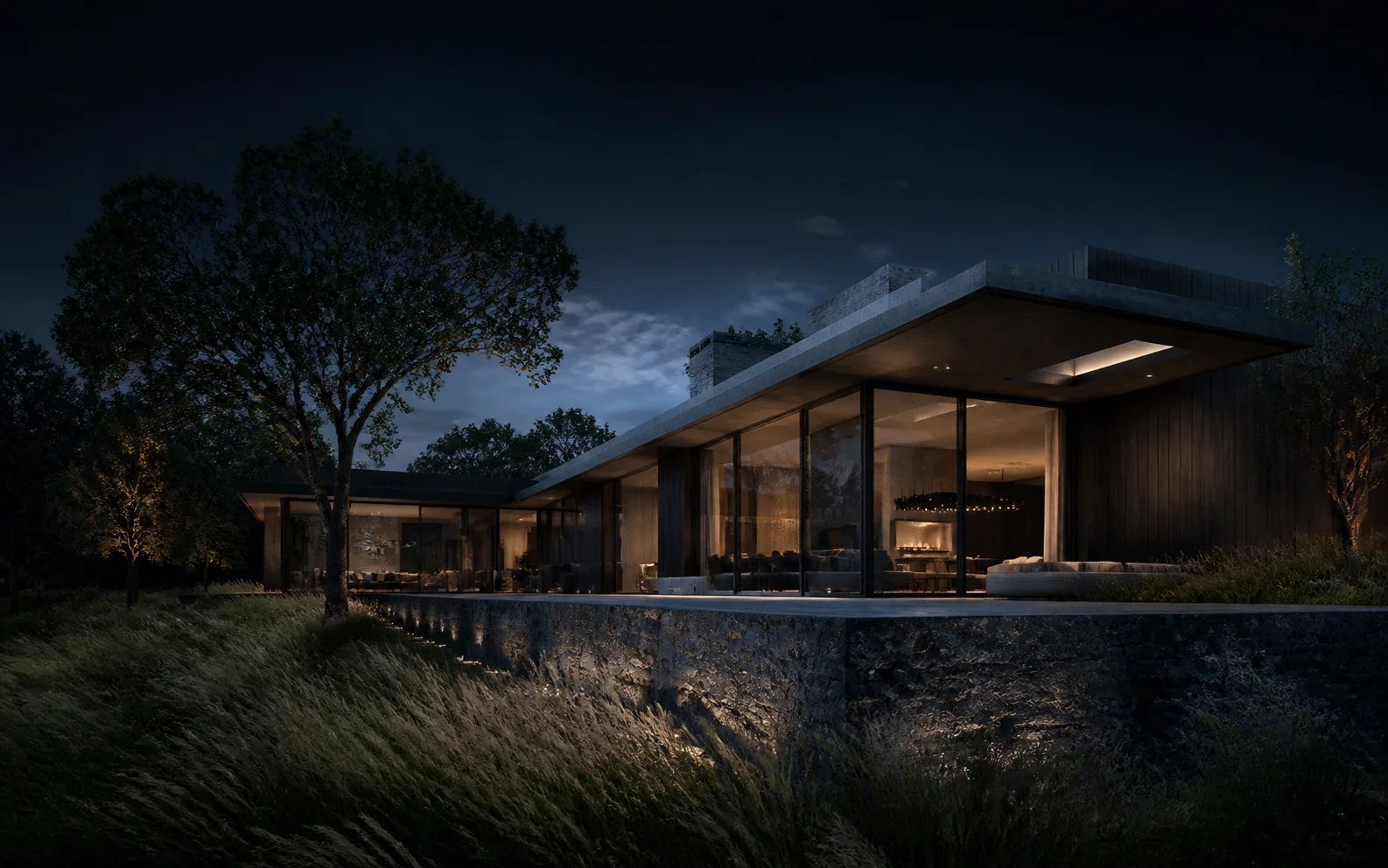 Low contemporary home glowing beside meadow grass at blue hour