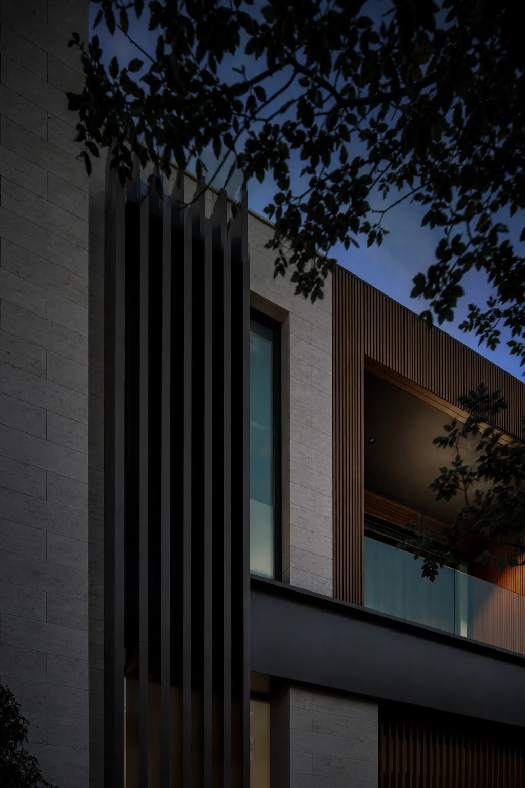 Limestone, timber, and metal residential facade
